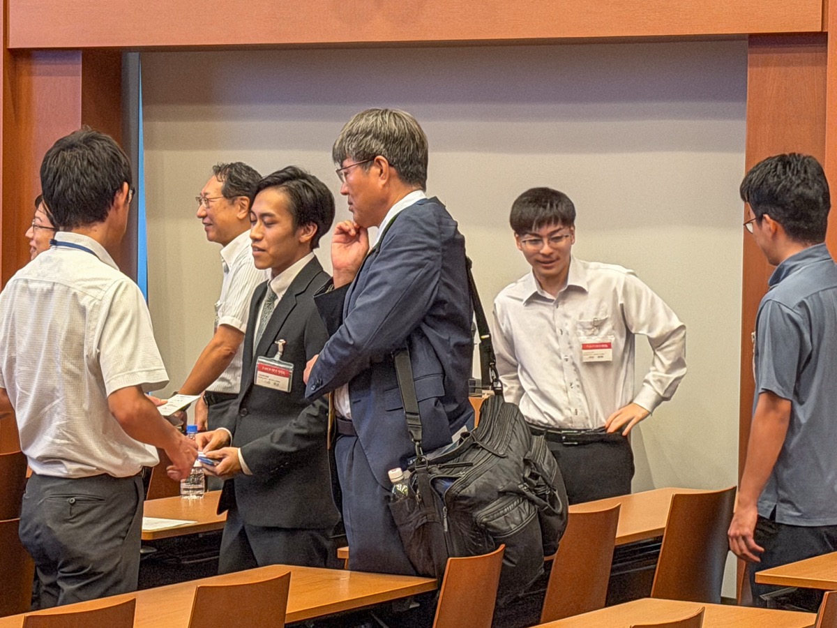 Participants exchanging business cards after the talks